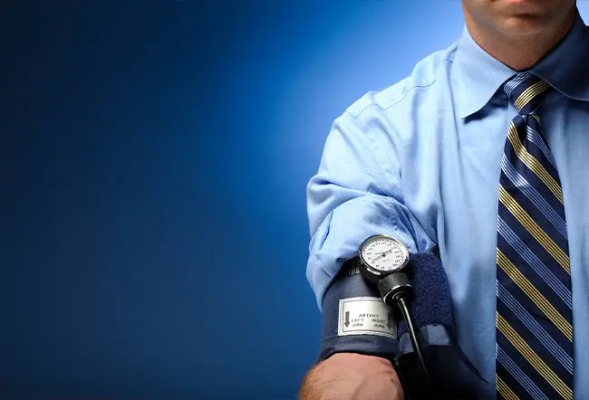 Man with a blood pressure sleeve on his arm